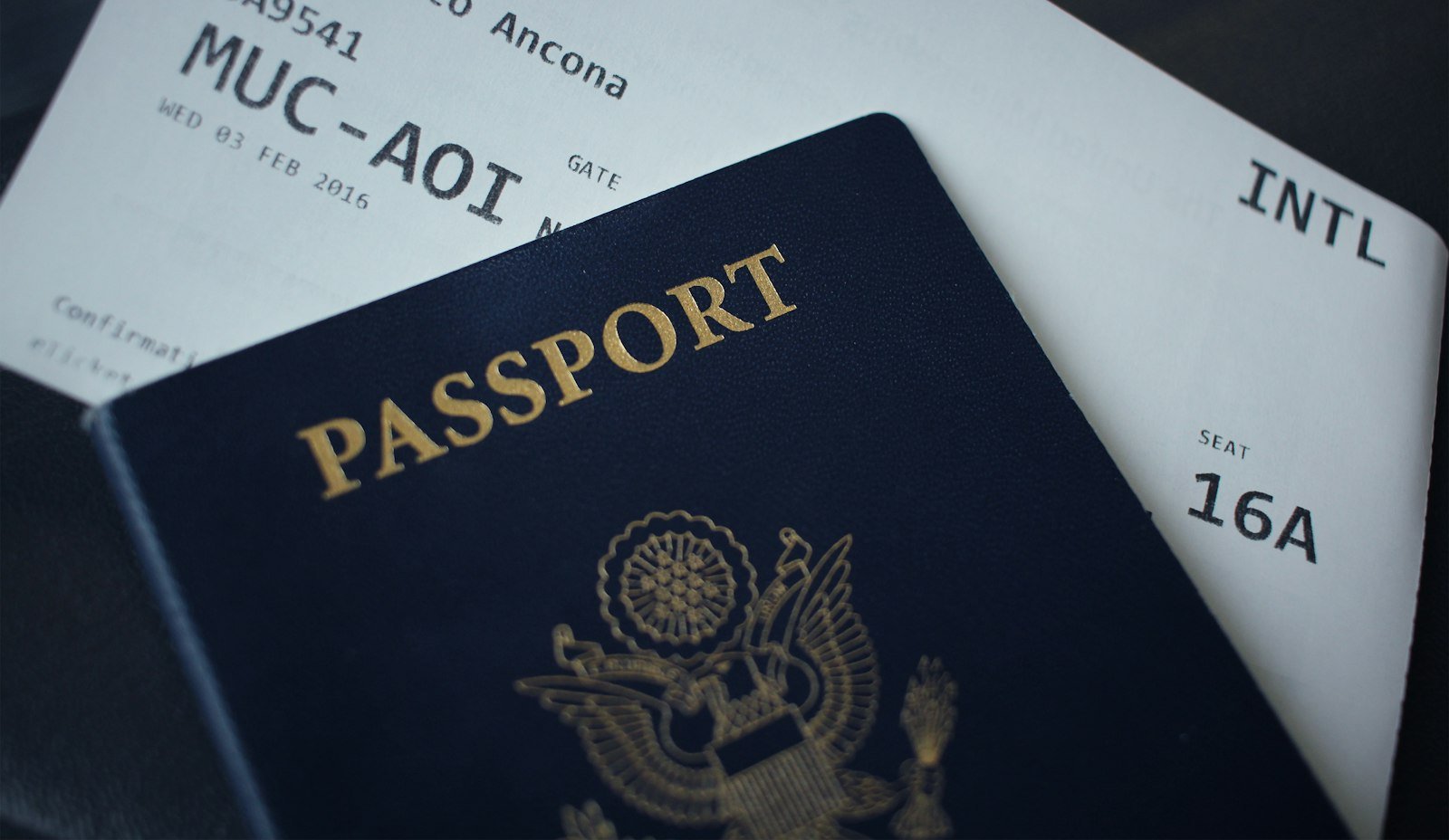 Passport booklet resting on white paper, representing study permit documents