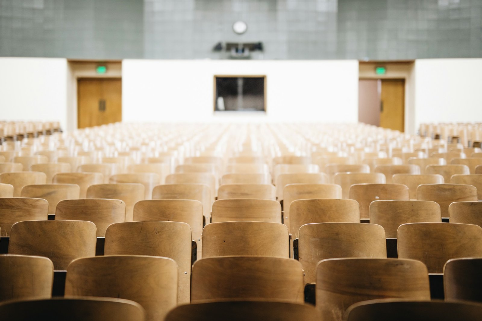 Empty university lecture hall with wooden seats